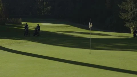 Golfing. Three players walking on golf course fairways. Stock Footage 142542873