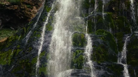 Gollinger Wasserfall cascading into a turquoise pool surrounded by rocks and Vídeo Stock 345177720