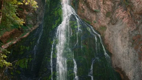 Gollinger Wasserfall cascading into a turquoise pool surrounded by rocks and Video stock 345177796