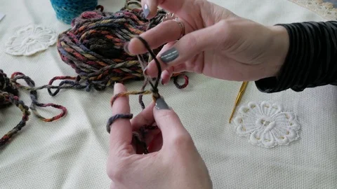 Gomel, Belarus - 04/02/2020: Woman's hands knitting with fingers without a hook Stock Footage 128929174