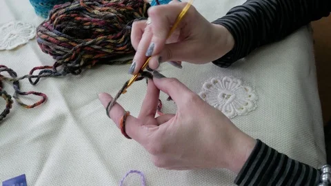 Gomel, Belarus - 04/02/2020: Woman's hands knitting from multi-colored threads Stock Footage 128929292