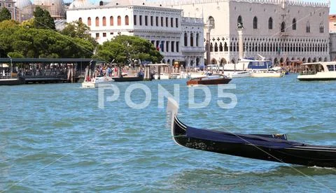 Gondola in the blue and limpid sea of Venice in Italy Stock Photos