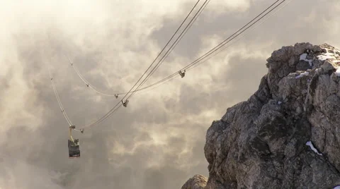 Gondola comes through the clouds up the mountain Stock Footage 58630260