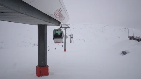 Gondola moving up and down the mountain above Les Menuires Ski resort in France. Stock Footage 84822774