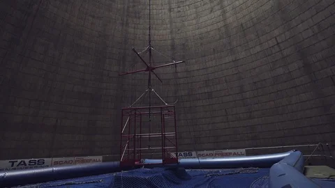 A gondola is placed inside the hollow center of the Orlando power plant Stock Footage 123799240