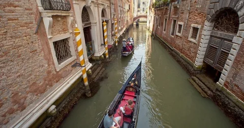 Gondola through a small side canal in venice Stock Footage 110810893
