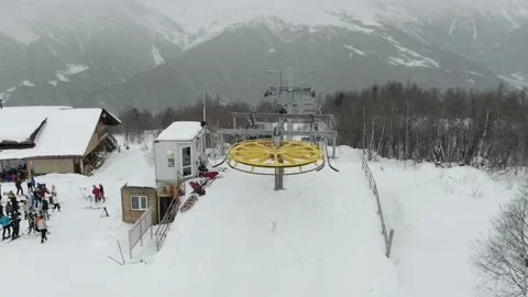 Gondola type cable car and skiers on snow covered slope of ski resort. Video stock 237822260