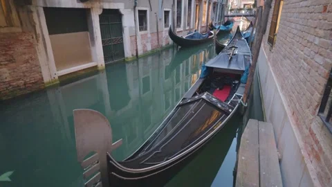 Gondolas Moored Along a Narrow Venetian Canal at Dusk Stock Footage 343340407