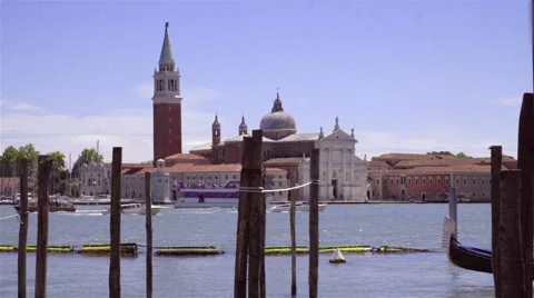 Gondolas moored by Saint Mark square with San Giorgio di Maggiore church Stock Footage 66064665