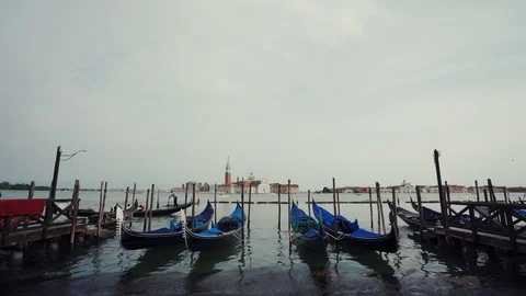 Gondolas moored by Saint Mark square with San Giorgio Maggiore church in Venice 库存影片 125274628