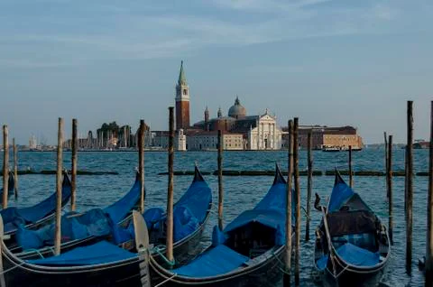 Gondolas moored by Saint Mark square and San Giorgio Maggiore Island Stock Photos