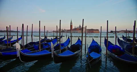Gondolas moored by Saint Mark's basin at sunset, Venice. Stock Footage 257934233