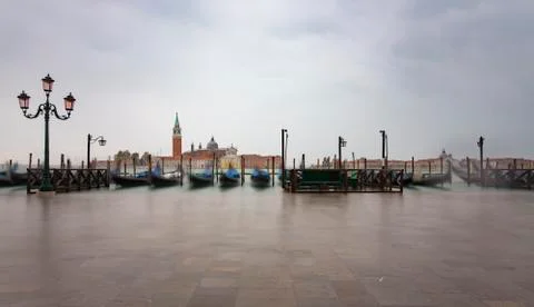 Gondolas by Saint Mark square during  with San Giorgio di Maggiore church in  Stock Photos