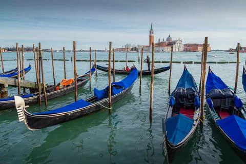Gondole and typical buildings at Venice with church in background, Italy Stock Photos