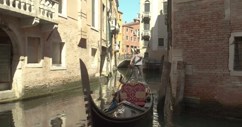 A gondolier sails on the lagoon Stock Footage 141690078
