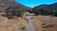 Good Aerial Following Two Mountain Bikers Riding In The California Mountains. Stock Footage