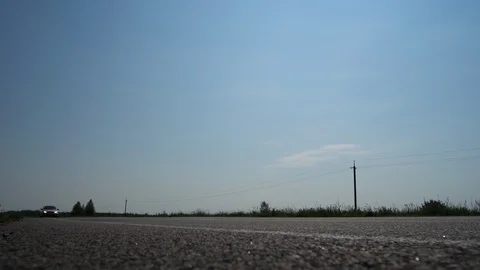 A good autobahn, a camera from below on the road, a car passes by the frame. 4K 库存影片 114890021