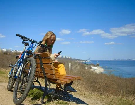 A good day for an active girl is a bike, a good view, sunny weather, a seasca Stock Photos