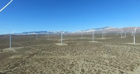 A good eye level aerial over a Mojave desert wind farm as it generates clean Video stock 107449645