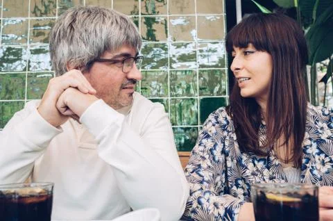 Good friends talking in a bar while having a drink Stock Photos