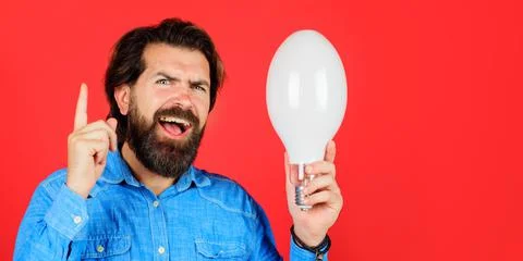 Good idea. Bearded man with light bulb shows finger up. Birth of ideas. Creat Stock Photos
