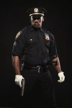 Good looking afro policeman posing with gun Stock Photos