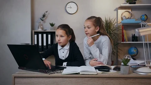 Good-looking balanced different ages girls sitting together at the table and Stock Footage 124698661