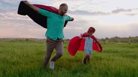 Good looking charismatic small boy and his dad running through the green field Stock-Footage 170010019