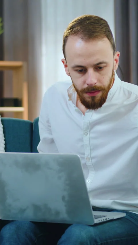 Good-looking concentrated skilled young bearded office manager working with fina Stock Footage 330251623