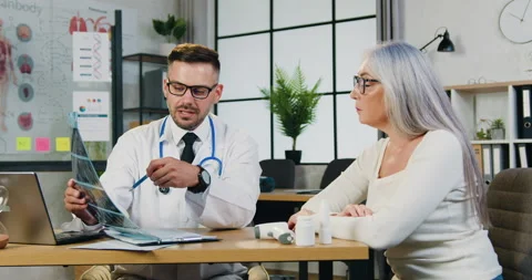 Good-looking confident experienced caring bearded doctor explaining results of x Stock Footage 160746188
