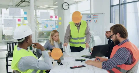 Good-looking confident experienced multiracial engineers in hardhats Stock Footage 145811705