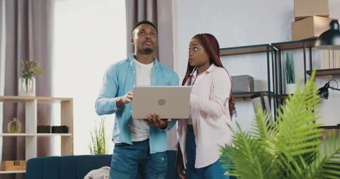 Good-looking confident satisfied young african american couple standing in newly Stock Footage 150699387