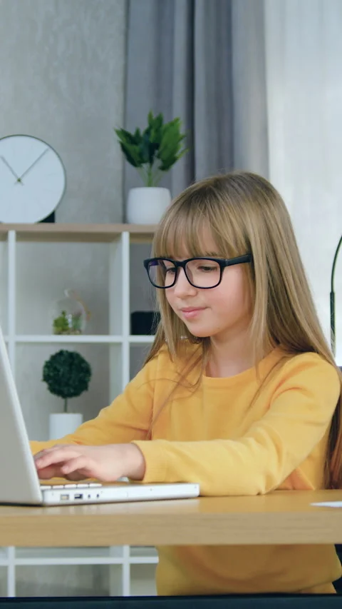 Good-looking confident smart modern 10-aged girl in casual clothes wears eyeglas Stock Footage 332730344