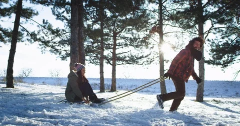 Good looking couple have a great time in the middle of a snowy forest they have Video stock 111829073