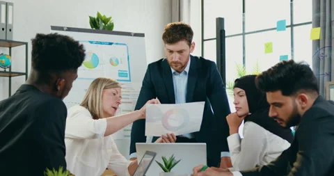 Good-looking creative multiracial group of coworkers working together with Stock Footage 159673089