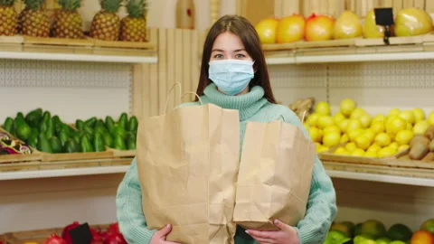 Good looking customer lady with protective after the end of the shopping in the Stock Footage 166525853