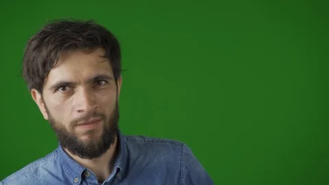 Good looking, dark-haired man playfully makes funny faces -grins, grimaces Vídeos de archivo 115032213