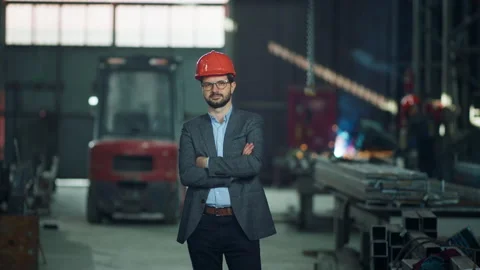 Good looking engineer in the industrial factory posing in front of the camera Stock Footage 255803492