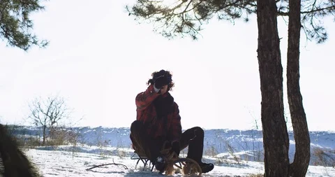Good looking expressive guy outside in a winter time on the sleigh he using a Stock Footage 111959563