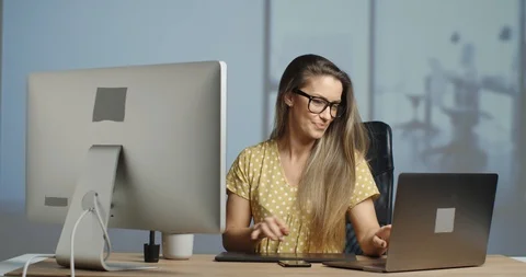 Good looking female graphic designer finishing her work day in her advertising Stock Footage 121474529