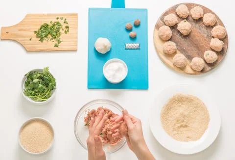 Good-looking female hands while preparing delicious traditional italian meatb Stock Photos