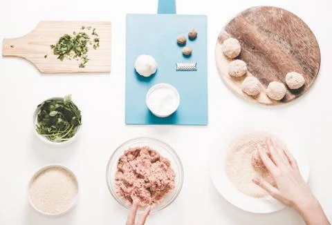 Good-looking female hands while preparing delicious traditional italian meatb Stock Photos