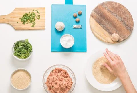 Good-looking female hands while preparing delicious traditional italian meatb Stock Photos
