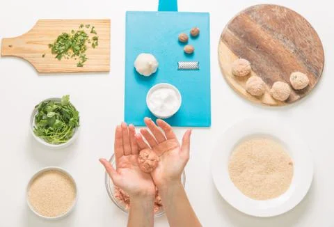 Good-looking female hands while preparing delicious traditional italian meatb Stock Photos