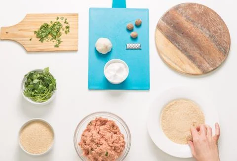 Good-looking female hands while preparing delicious traditional italian meatb Stock Photos