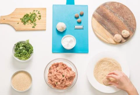 Good-looking female hands while preparing delicious traditional italian meatb Stock Photos