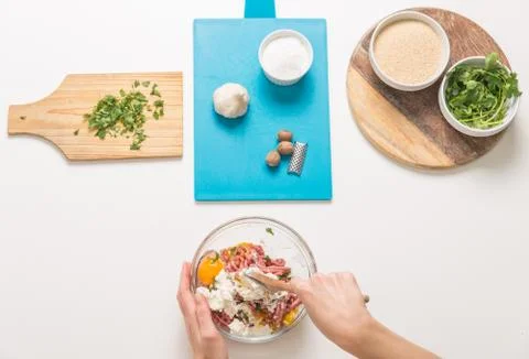 Good-looking female hands while preparing delicious traditional italian meatb Stock Photos