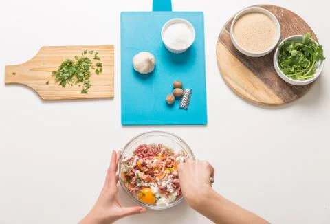Good-looking female hands while preparing delicious traditional italian meatb Stock Photos