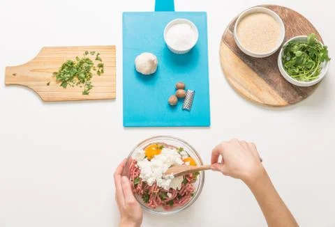 Good-looking female hands while preparing delicious traditional italian meatb Stock Photos