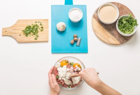 Good-looking female hands while preparing delicious traditional italian meatb Stock Photos